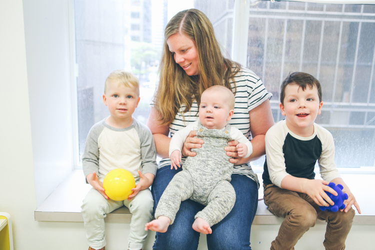 Mom and kids exploring a classroom