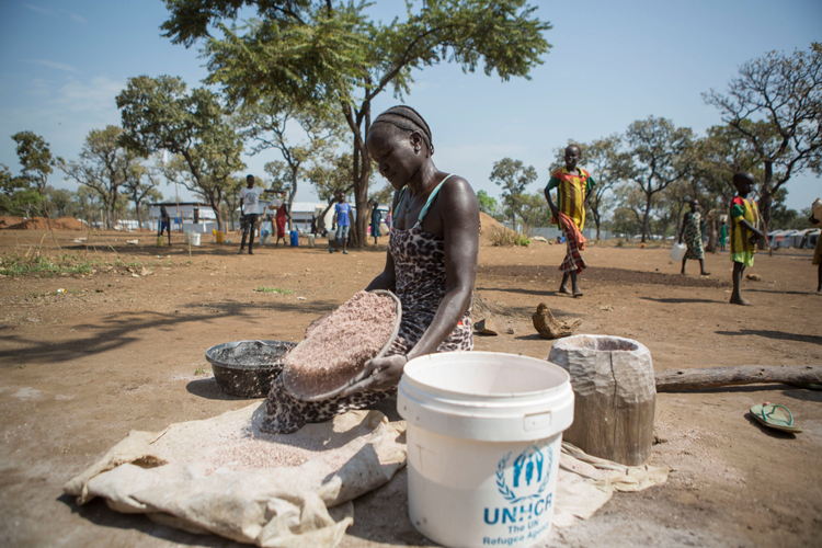 A woman living in the Nguneyyiel refugee camp cleans and sorts grains before cooking on 26 Nov 2017. Photographer: ZACHARIAS ABUBEKER A woman living in the Nguneyyiel refugee camp cleans and sorts grains before cooking on 26 Nov 2017. Photographer: ZACHARIAS ABUBEKER