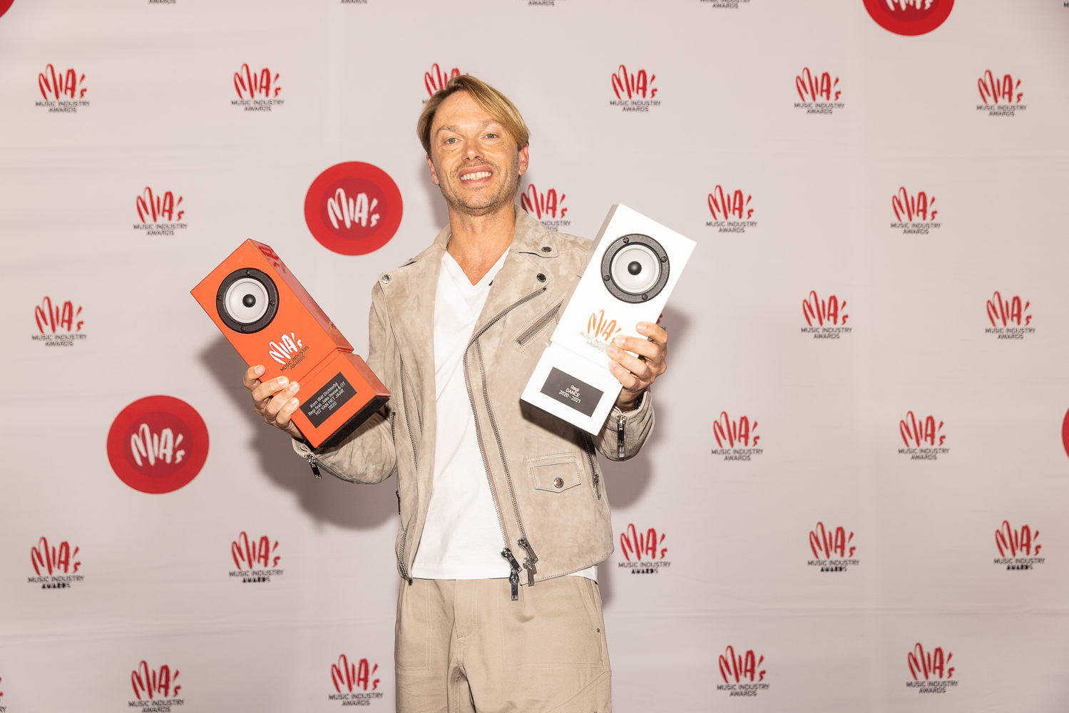DJ Regi Penxten poses with awards won at the 14th edition of the MIA's