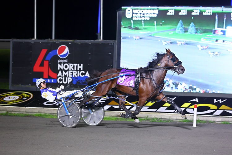 Legendary Hanover and driver James MacDonald winning the first Champlain division on September 9, 2023 at Woodbine Mohawk Park (New Image Media) 