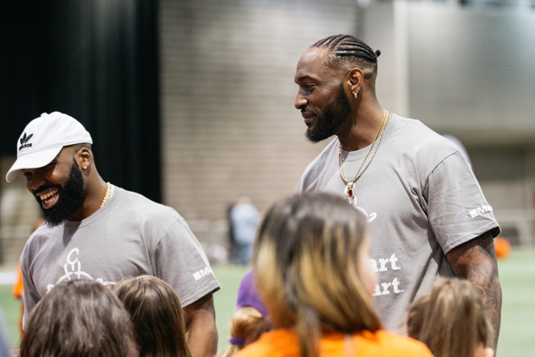 Simoni Lawrence (L) and Willie Jefferson (R) interact with participants at the JumpStart Games. Photo credit: CFL.ca/Reid Valmestad