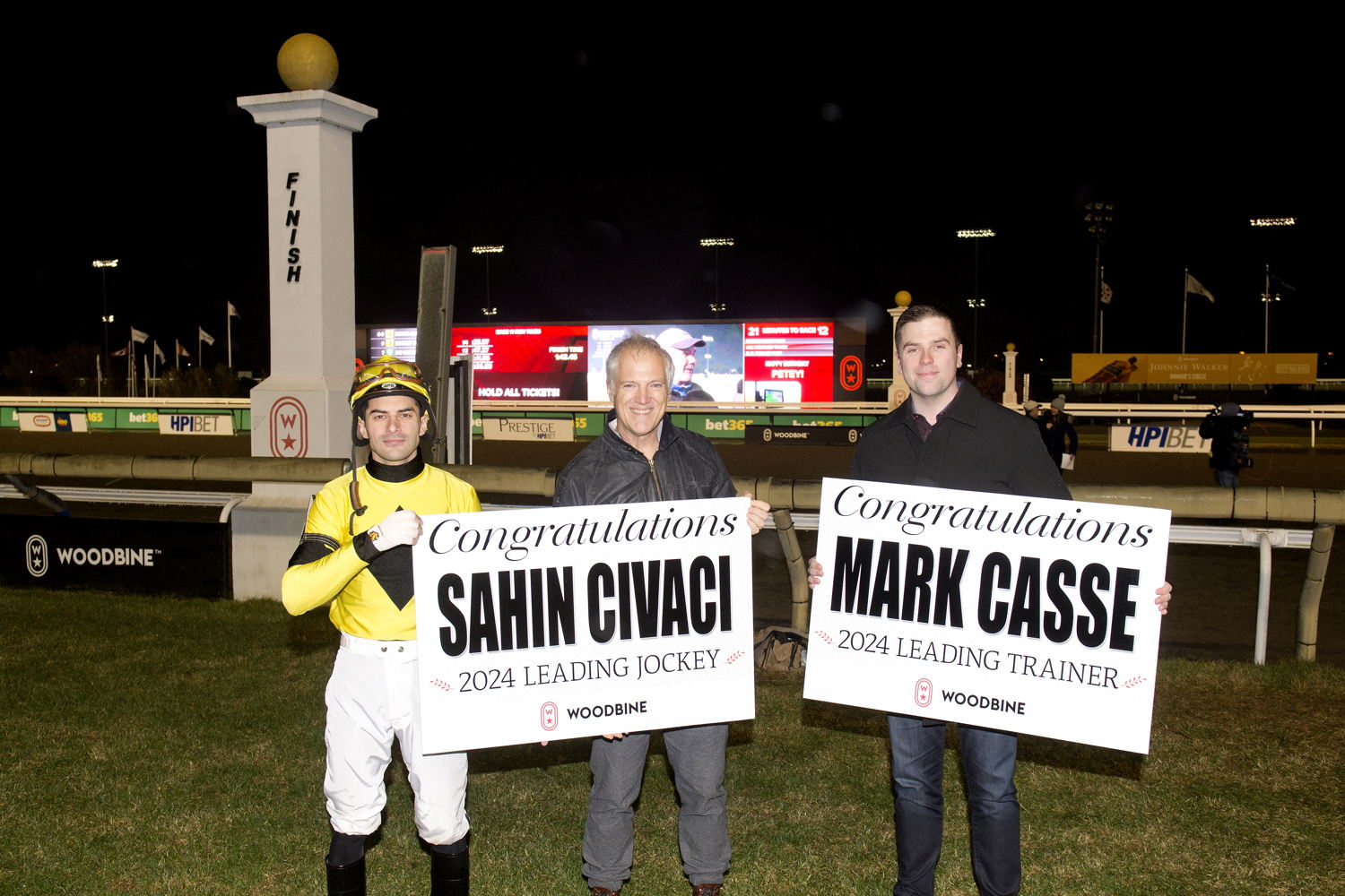 Sahin Civaci, EVP of Racing Bill Ford, and Sr. Manager of Communications Mark McKelvie celebrate the Meet Leading titles at Woodbine (Michael Burns Photo)