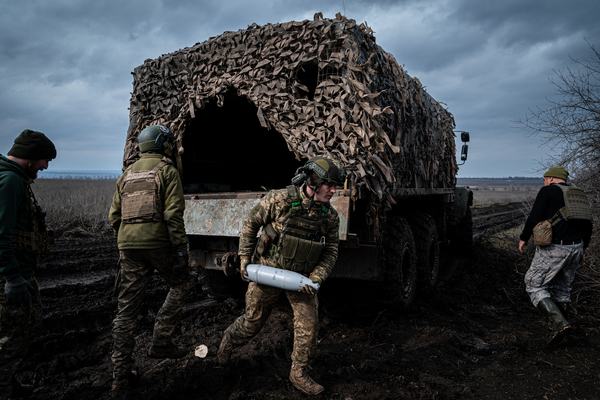 DONETSK, UKRAINE - MARCH 11: Ukrainian servicemen from the 10th Brigade unload heavy artillery ammunition at a position along the frontline outside of Soledar, Ukraine