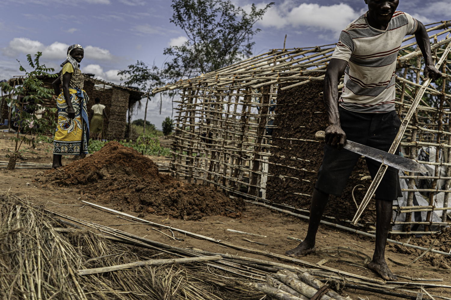 Cabo Delgado: Mapupulo IDP site
At the Mapupulu site for internally displaced persons a man who had recently arrived after fleeing armed conflict in Cabo Delgado is seen putting together the frame for the hut he is building on his plot in the camp. Photographer: Tadeu Andre