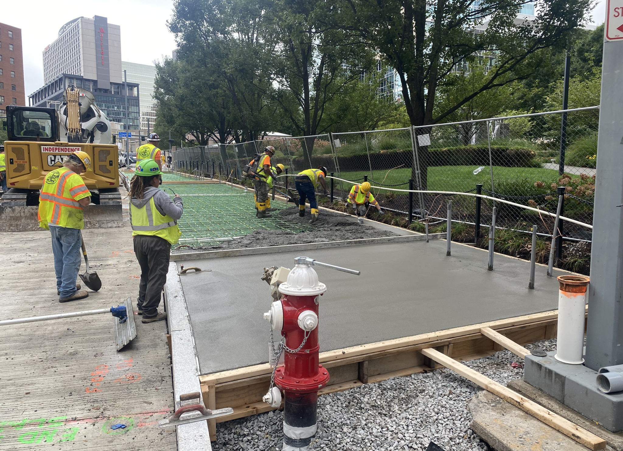 Contractors placing new concrete sidewalk at Steel Plaza Station
