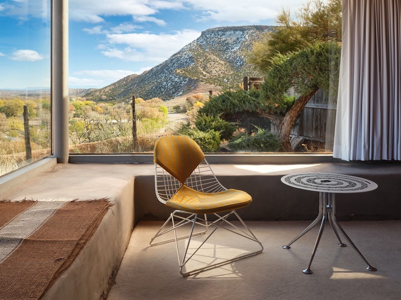 The Eames Wire Chair Low Base designed by the Eames Office for Herman Miller and the Girard Snake Table designed by Alexander Girard for Herman Miller; Photos by Mariko Reed for Herman Miller