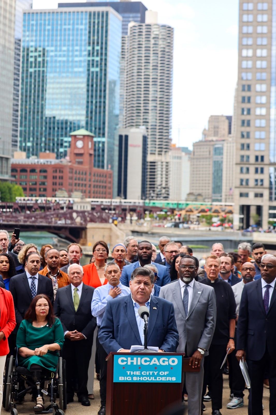 Gov. Pritzker stands alongside business, education, religious, and community leaders to emphasize that there is no emergency in Chicago warranting a National Guard deployment at a press conference on the River Front. (Office of the Governor)