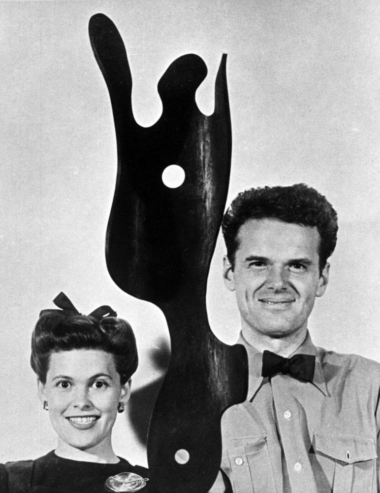 Charles and Ray posing for their Christmas card, with a sculpture carved from a molded plywood leg splint, in 1944