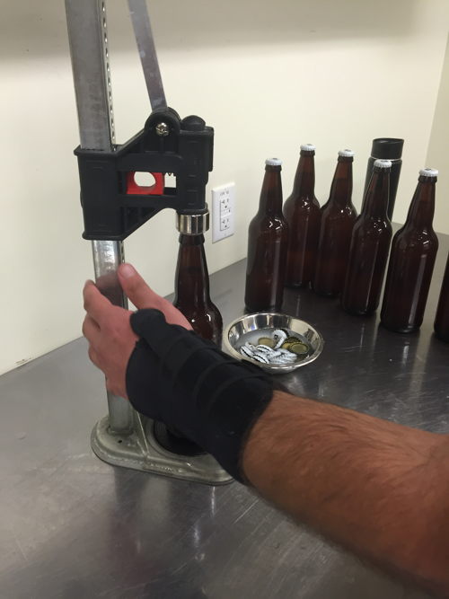 William Brant of CO-Brew caps the bottles of cantaloupe gose beer