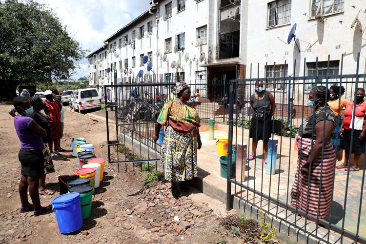 Residents of the suburb of Mbare, in Zimbabwe's capital city of Harare collect water from a water point. The water point is one of many in the city connected to a newly drilled or rehabilitated boreholes providing residents with easy access to clean and reliable water sources. Photographer. Dorothy Meck