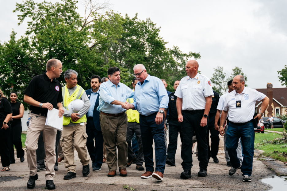 Governor Pritzker surveys the damage to the Lansing community, joined by Ted Berger, Acting Director of Illinois Emergency Management Agency and Office of Homeland Security; Gil Quiniones CEO of ComEd; Brian Hardy, Mayor of Lansing; Chad Kooyenga, Lansing Fire Chief; and Zoran Savic, Building Commissioner for the Village of Lansing (left to right).