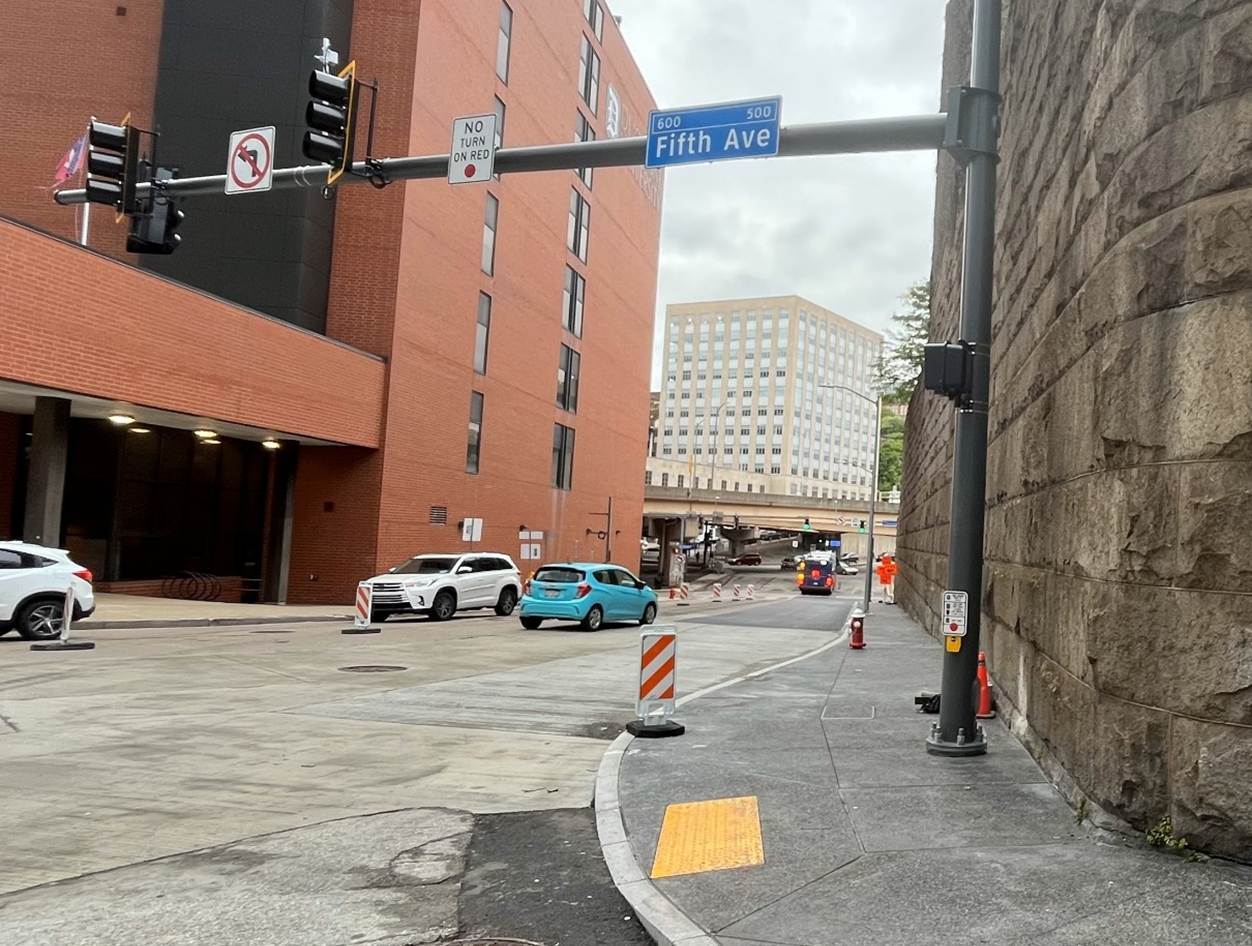 New sidewalk with accessible ramps recently installed on Sixth Avenue at Fifth Avenue