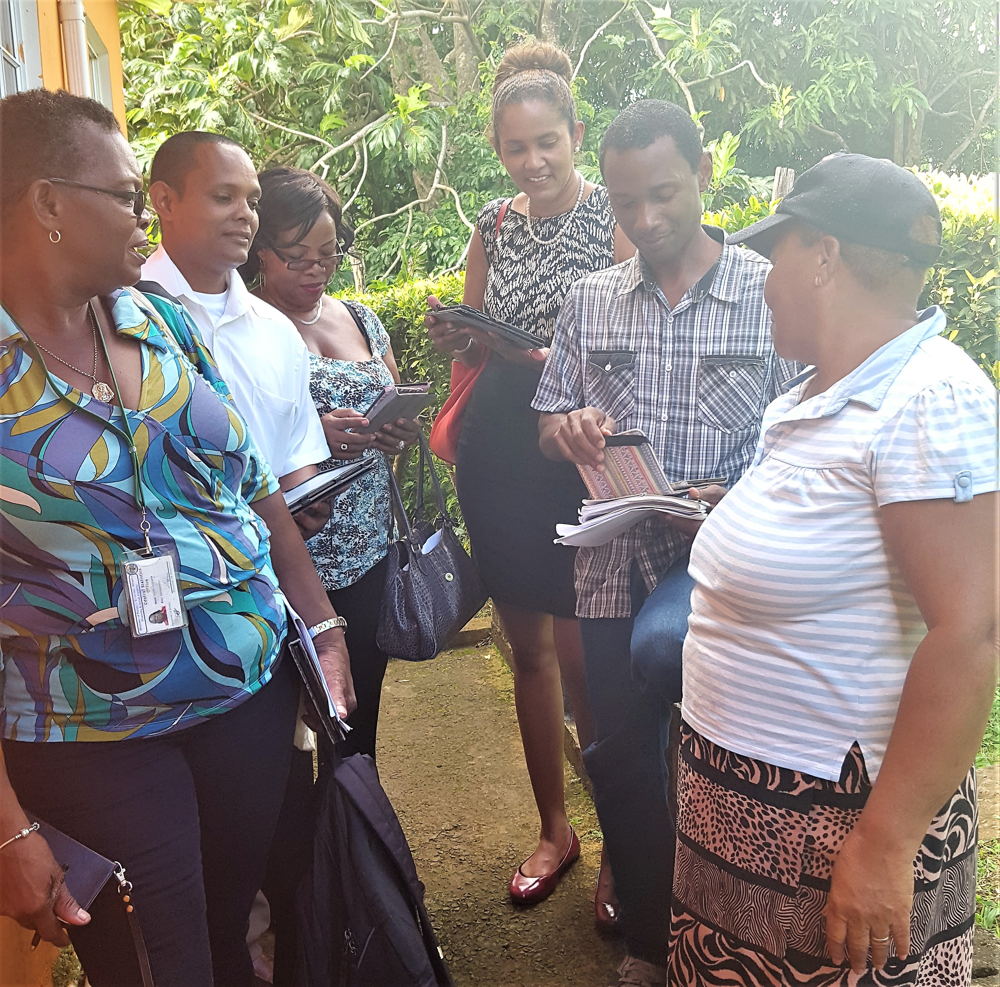 OECS Statistical Services Unit (SSU) and St. Lucia's Central Statistical Office (CSO) staff members conducting a survey with the use of tablets.