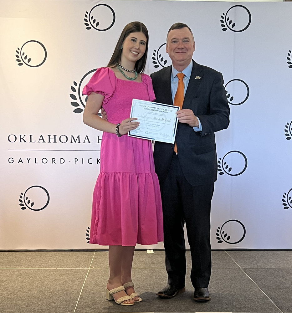 Conners State College President Ron Ramming presenting scholarship to Jade Shawn-Marie McPeak
