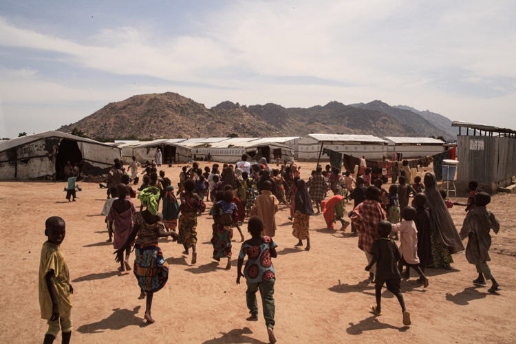 Children run after an MSF health promoter near Pulka transit camp. Photographer: Scott Hamilton