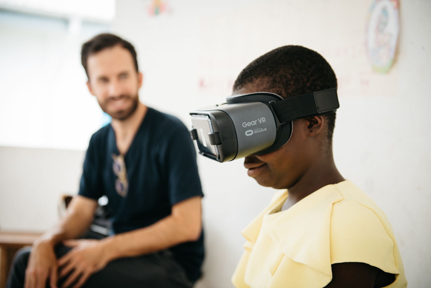 Edith VR screening Edith, a Mercy Ships patient from Cameroon, watches a virtual reality film with director Armando Kirwin, left. Kirwin’s film “Mercy” documents Edith’s life-changing transformation through Mercy Ships.