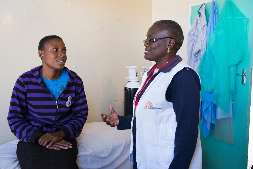 24 year old Tracy speaks with a member of MSF staff. 

Tracy had HPV and was tested for VIAC without knowing it. They discovered in November 2015 more than 75% lesions. SHe was referred to Harare, thanks help from Medecins Sans Frontieres (MSF), and LEEP. Her son was hit by a car 3 weeks ago, so she has been stuck at Gutu Mission Hospital with him and has not been able to go back to VIAC test to see if the lesions are still there. Photographer: Melanie Wenger/COSMOS