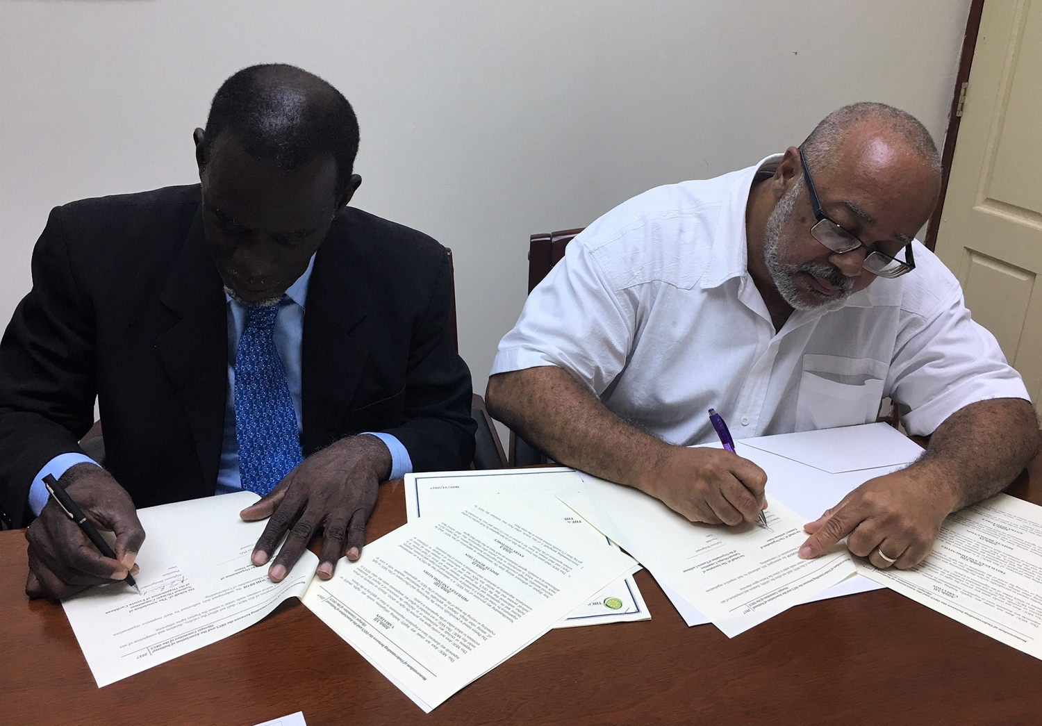 OECS Director General, Dr. Didacus Jules, and Mr. Alphonso Bridgewater, President of the ANOCES, complete MOU signing.