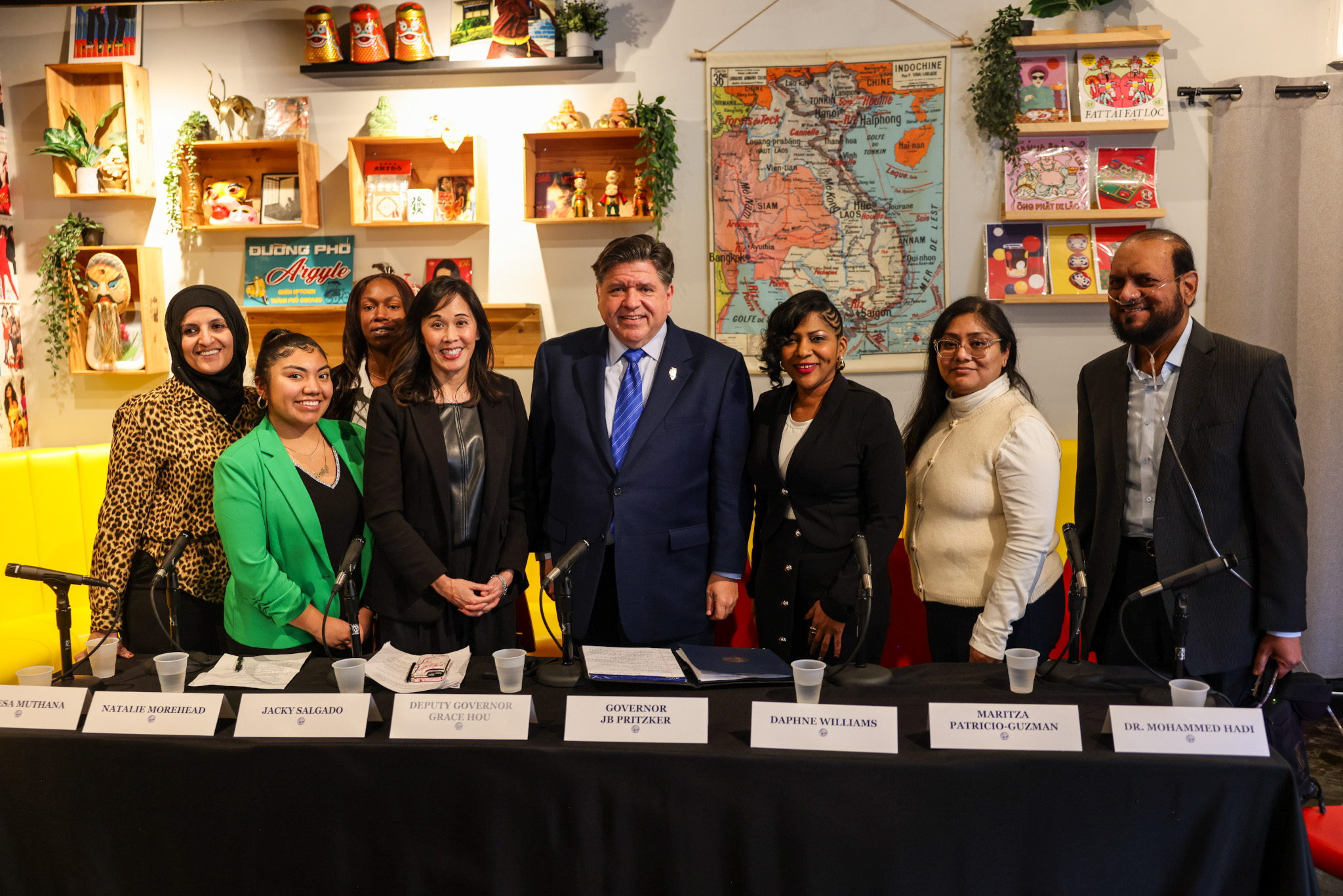 Governor Pritzker stands with roundtable participants after discussing the impacts of the federal government's reckless policies on Illinoisans, one year after Donald Trump's return to the White House. (Office of Governor Pritzker)