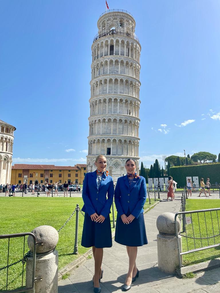Cabin crew in front of the Leaning Tower of Pisa