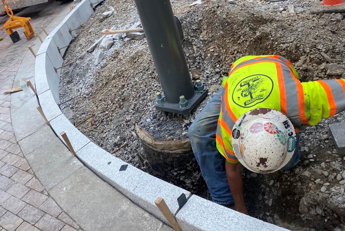 Granite curb being installed at Fifth Avenue and Grant Street along with new accessible ramps