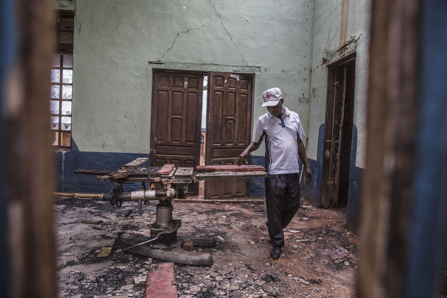 Jean Paul Buana, nurse and director of the Mayi Munene health centre, examines the damage to the operating theatre. 
“When we first saw what they had done to the centre, we cried. There was nothing else to do but cry. All our work has been lost. Between March and June, the centre did not function at all. We only came back in July because the security improved. Now there are six of us working here, but the needs are huge. We lack medicines and equipment, and safe space to work.”