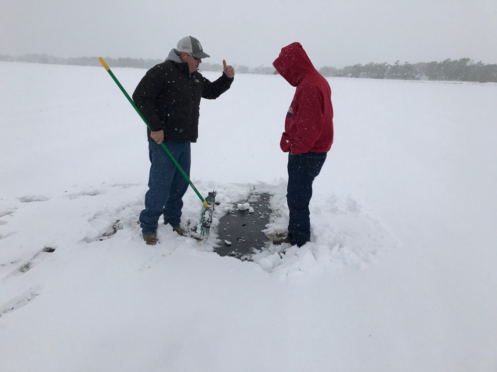 Proctor Produce's Matthew Proctor and Hirakata Farm's Michael Hirakata inspect a snowy cantaloupe field, April 2017