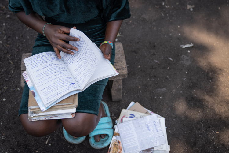 Rebecca would like to return to her studies and become a doctor, often looking through her old school notes for inspiration. Copyright: Moses Sawasawa