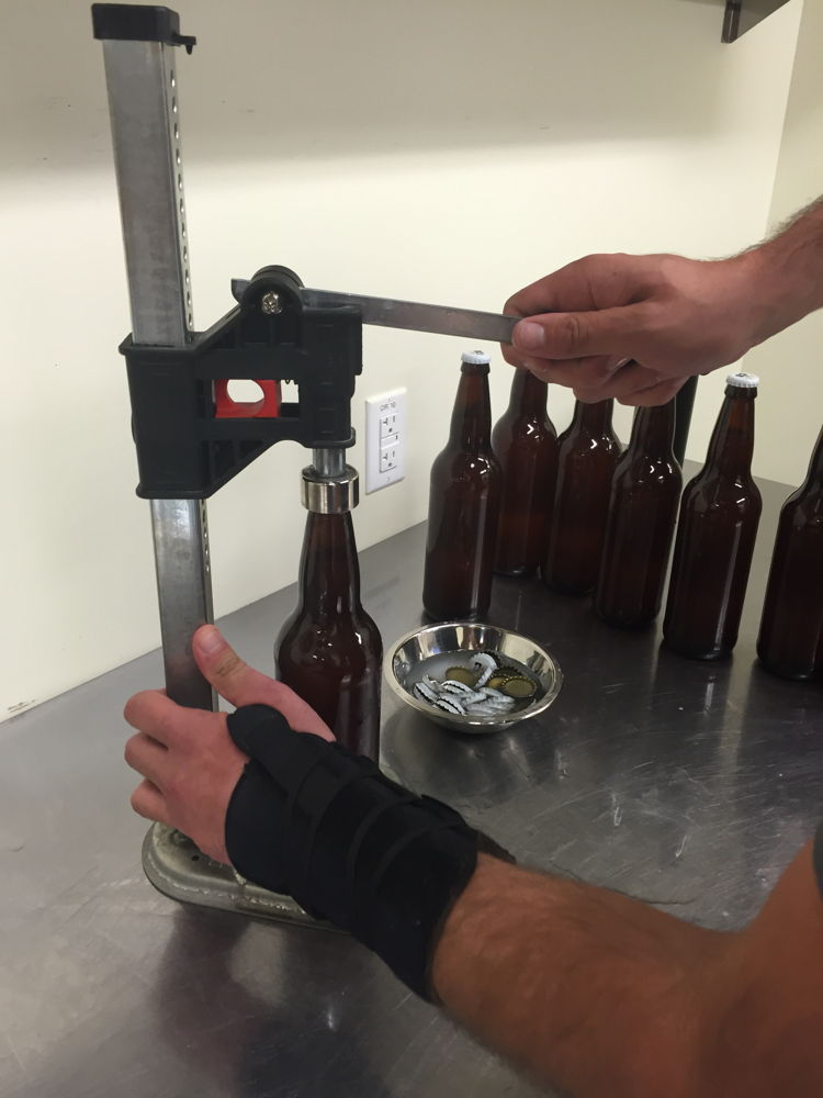William Brant of CO-Brew caps the bottles of cantaloupe gose beer