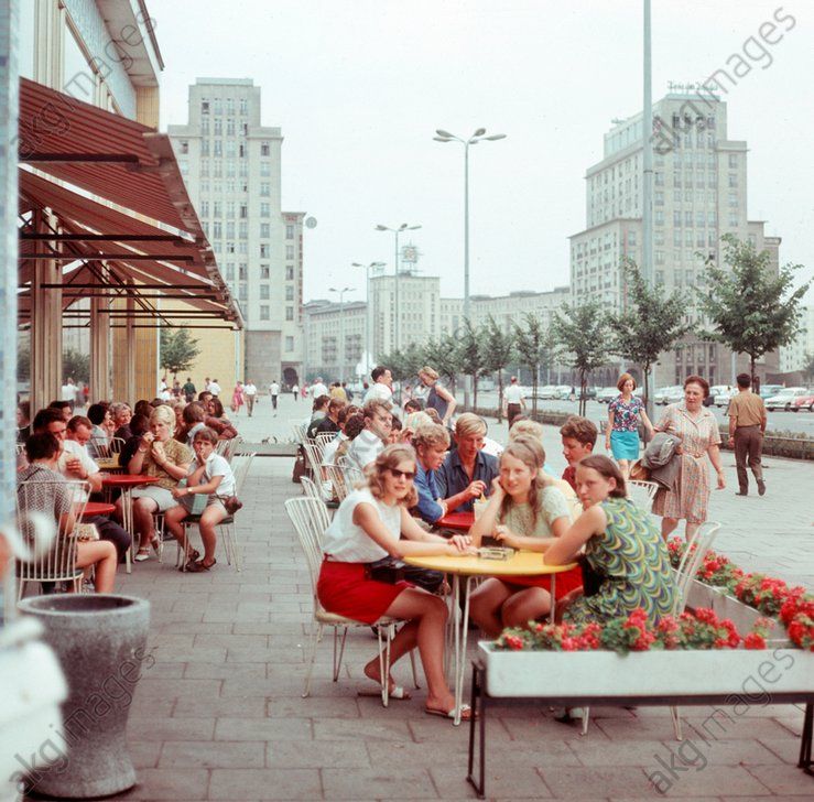 Modern new buildings are designed to give East Berlin, the capital of the GDR, the face of a socialist city - here families eating ice cream in the popular ice bar on Karl-Marx-Allee. Berlin 06.08.1970 ​ / AKG1893034
