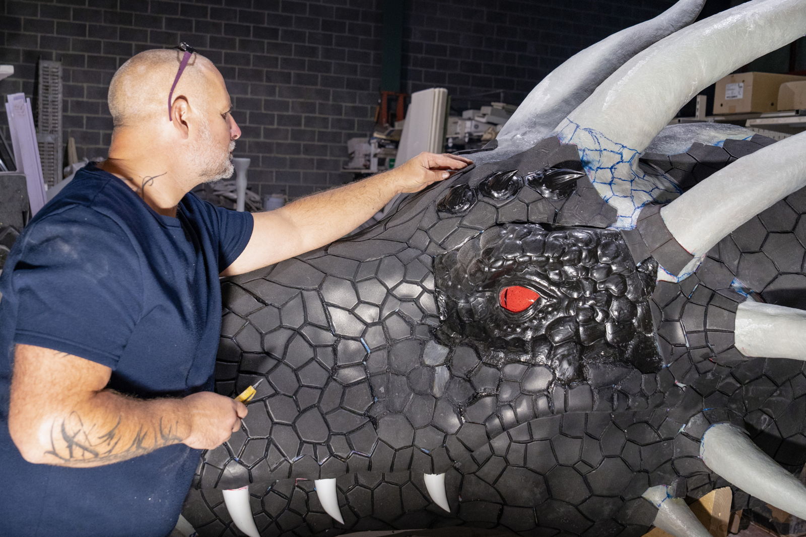 Dominique Maghue constructing a monumental 11-meter-long and over 3-meter-high Chinese dragon