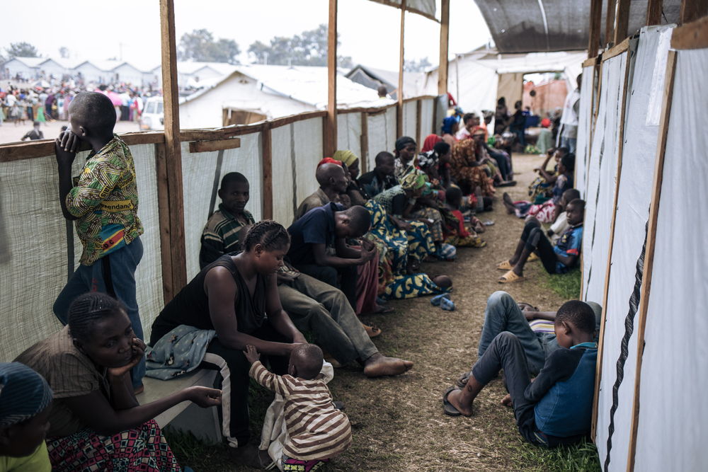 Patients wait their turn for a medical consultation at the MSF mobile clinic at Rugabo Stadium, which has been transformed into a site for war-displaced people, in Rutshuru Center, in North Kivu province, eastern Democratic Republic of Congo. Photographer: Alexis Huguet