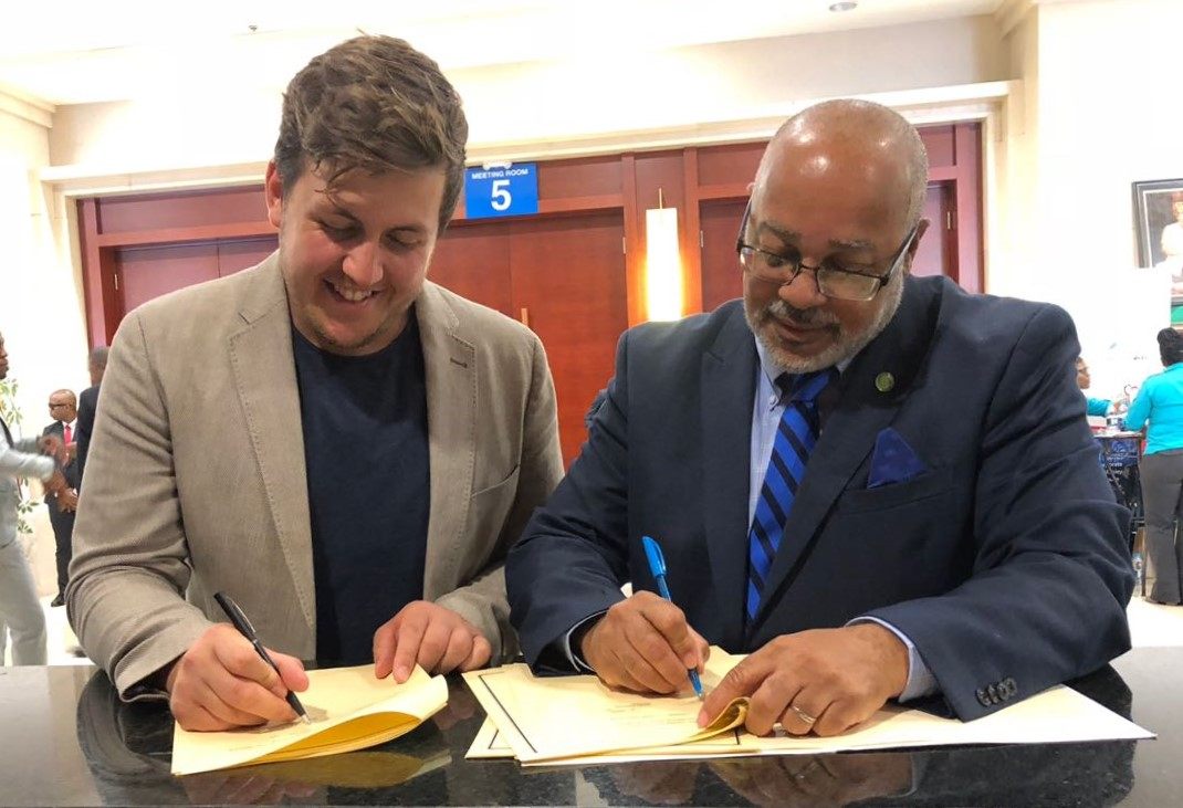 Dr. Didacus Jules, Director General of the OECS Commission and Mr. James Ellsmoor, Director of SHOS sign Memorandum of Understanding.
