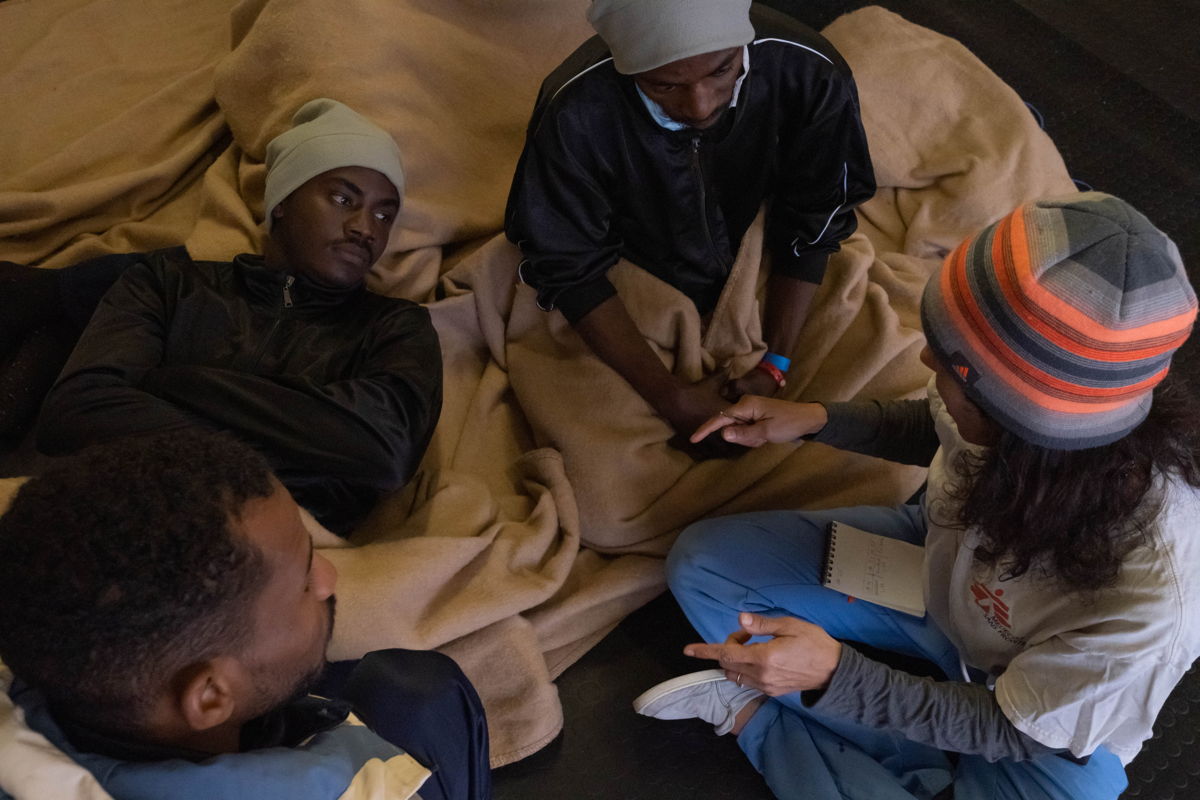 Cultural Mediator Nejma Banks converses with some survivors aboard the Geo Barrents