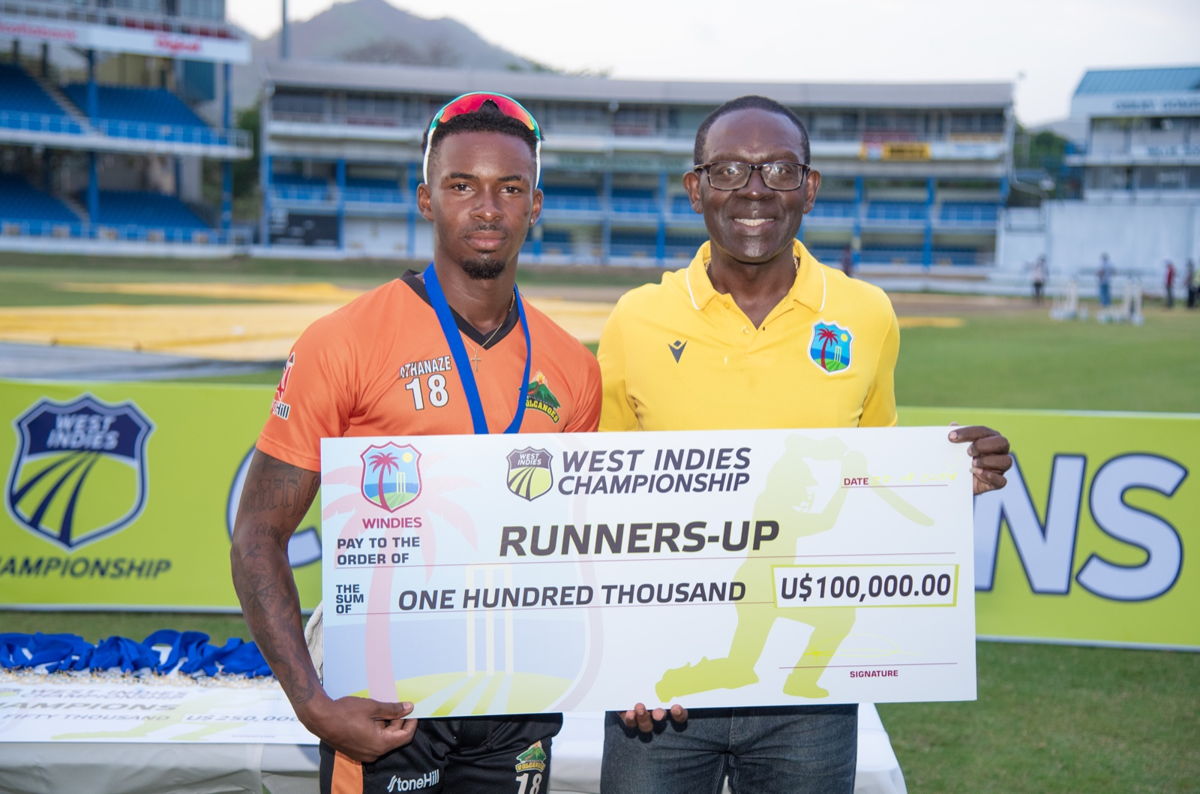 CWI Director Enoch Lewis presenting the $100,000 USD  runners-up cheque to Alick Athanze.