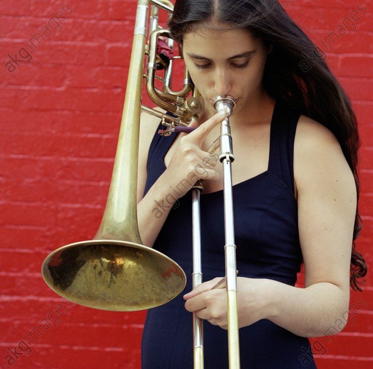 AKG3543415 - Reut Regev Playing the Trombone on the Roof of a House, New York. photo: Jean-François Labérine