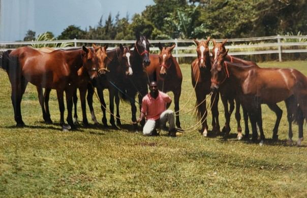 Leroy Trotman posing with the horses he loves. (Supplied) 