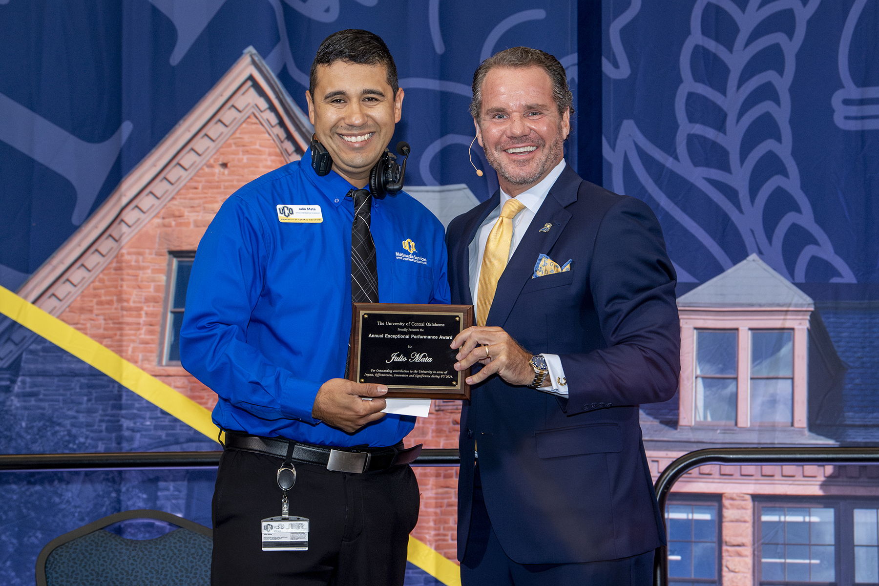 Alt Text: Pictured, left to right, Julio Mata, manager of media services, and UCO President Todd G. Lamb at the university's annual Faculty and Staff Convocation.