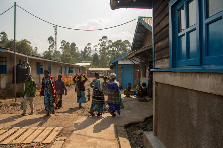 Patients and carers walking in front of the 40-bed paediatric care unit, inside the general referral hospital of Mweso, North-Kivu, supported by MSF teams since 2005 in partnership with the Ministry of Health. Between January and June 2023, more than 16,200 admissions were recorded in the paediatric unit. Copyright : Laora Vigourt/MSF