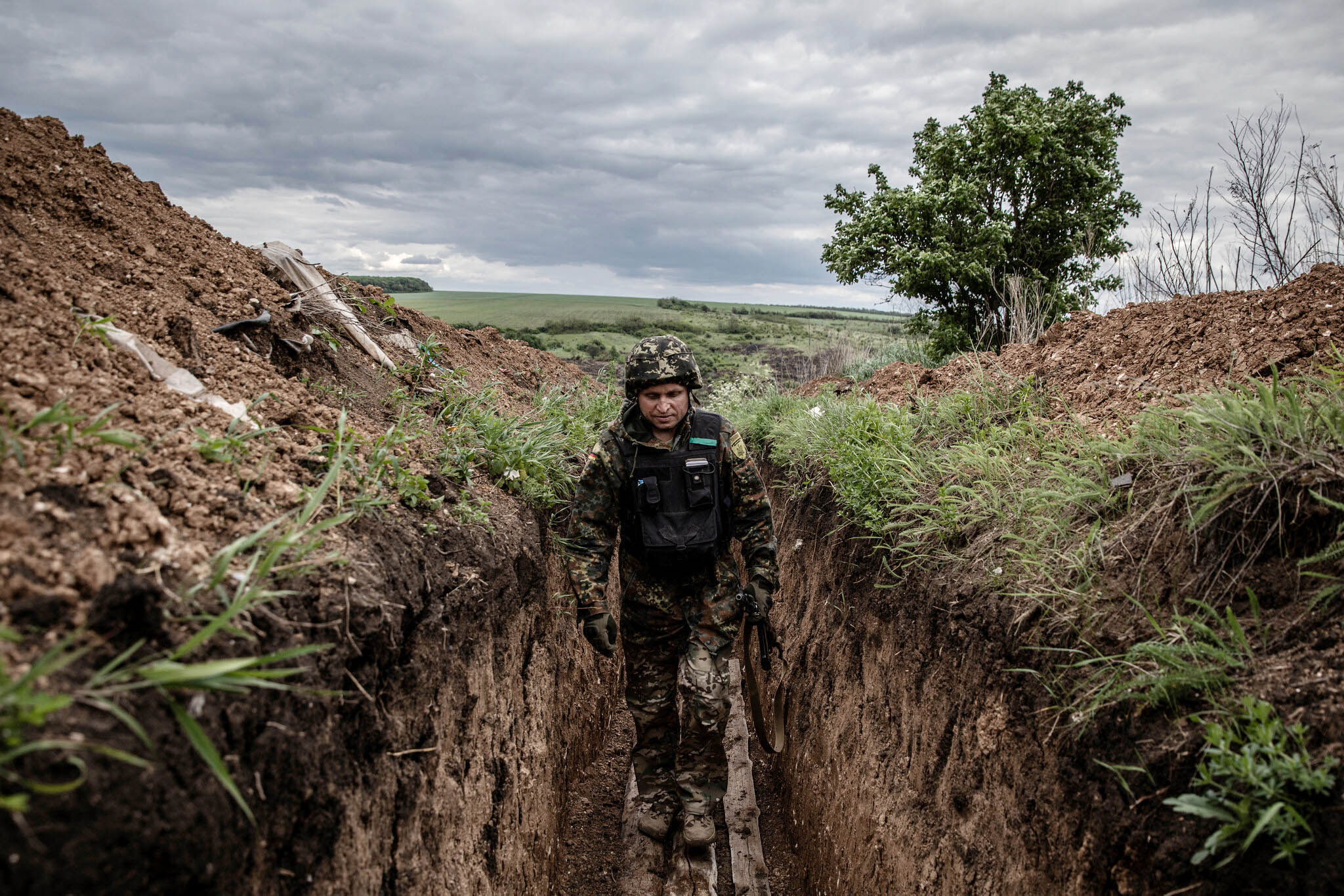 A Ukrainian soldier with the Territorial Defense Forces in a trench on May 22 on the front line in the eastern Donetsk region.  Finbarr O'Reilly for The New York Times