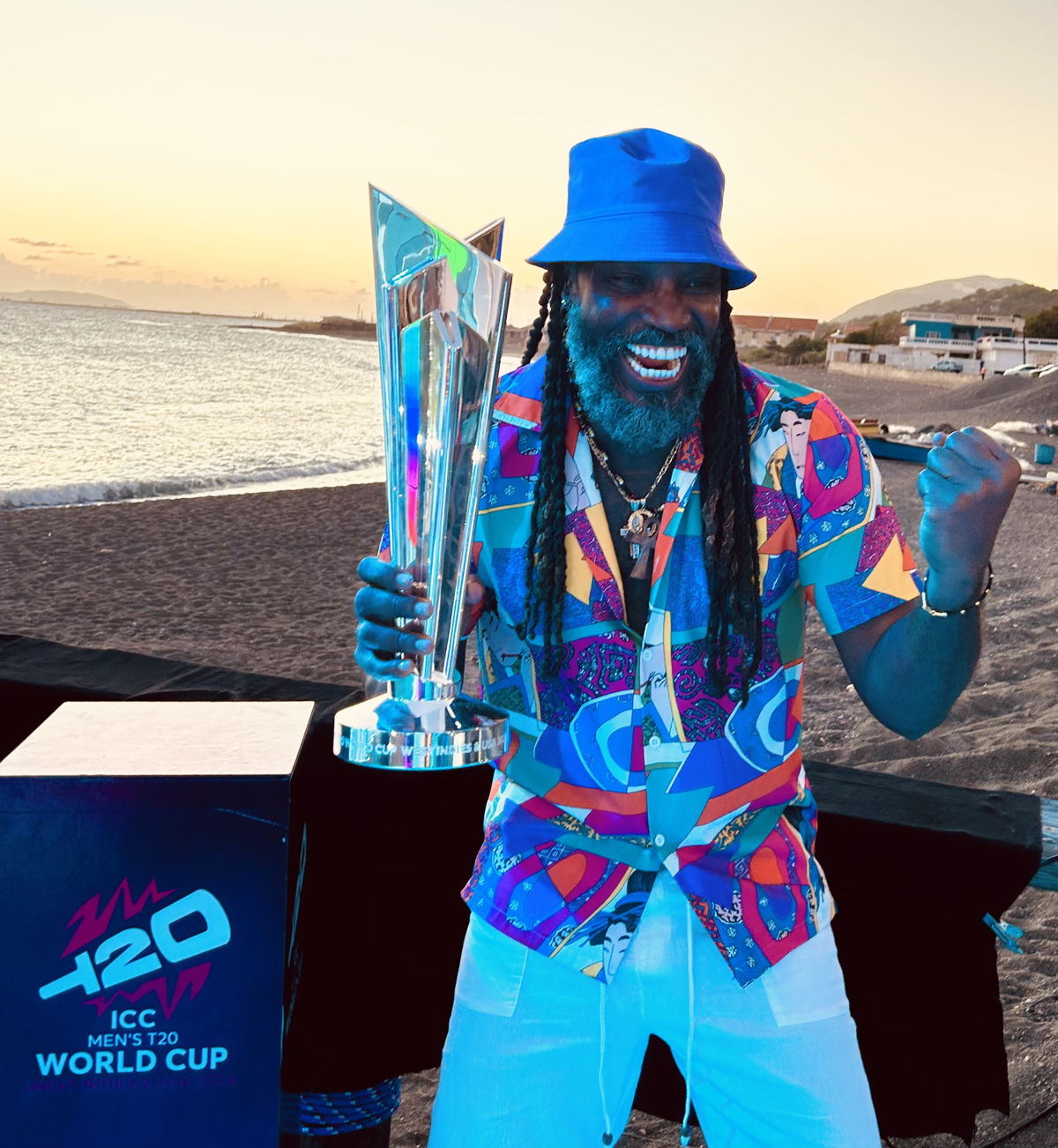 Chris Gayle, two-time winner of the ICC Men’s T20 World Cup with the trophy.