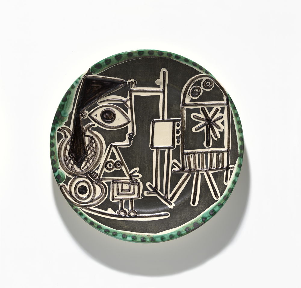 Pablo Picasso, Madoura Pottery, Vallauris (manufacturer) France 1938–2007, Jacqueline at the easel, round dish 1960, earthenware edition of 200, 3.6 × 42.3 cm diameter, National Gallery of Victoria, Melbourne Gift of Krystyna Campbell-Pretty AM and Family through the Australian Cultural Gifts Program, 2020 © Succession Picasso/Copyright Agency, 2022 Photo: NGV