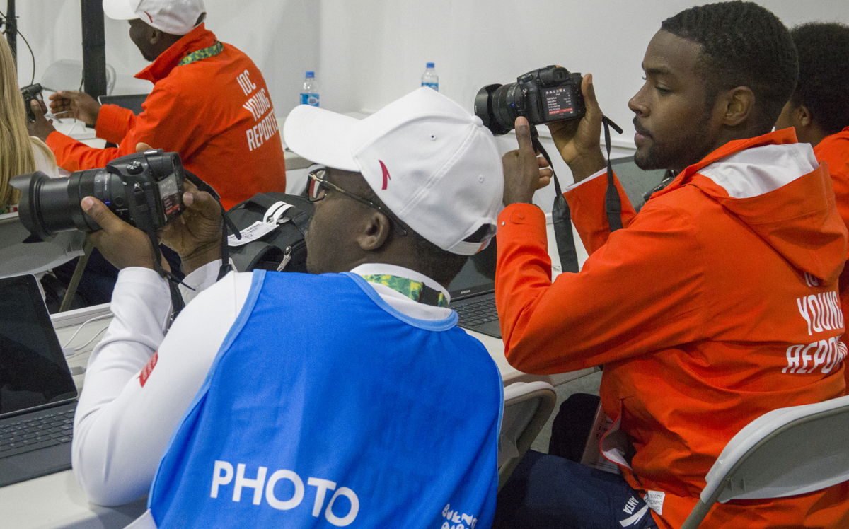 Sharome (right) engaged in photography class alongside fellow Young Reporter, Yao Bernard Adzorgenu of Togo
