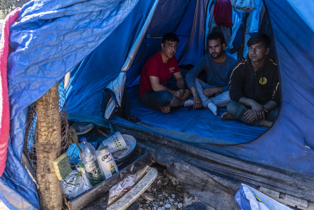 Mansoor (centre) is 21 years old and from Afghanistan. Home for the past few months has been this summer tent alongside his two friends in bushland outside Vathy camp on Samos. Mansoor says he has no access to clean water to wash himself or his clothes and cannot even access a toilet. Credit: Anna Pantelia/MSF, 7 March 2019