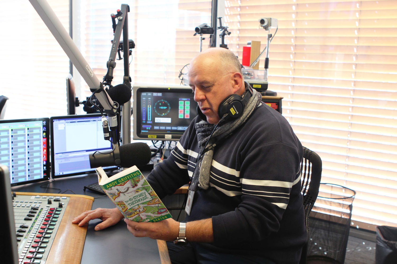 Mornings Presenter, Steve Austin, with his daughter's favourite book, 65-storey Treehouse