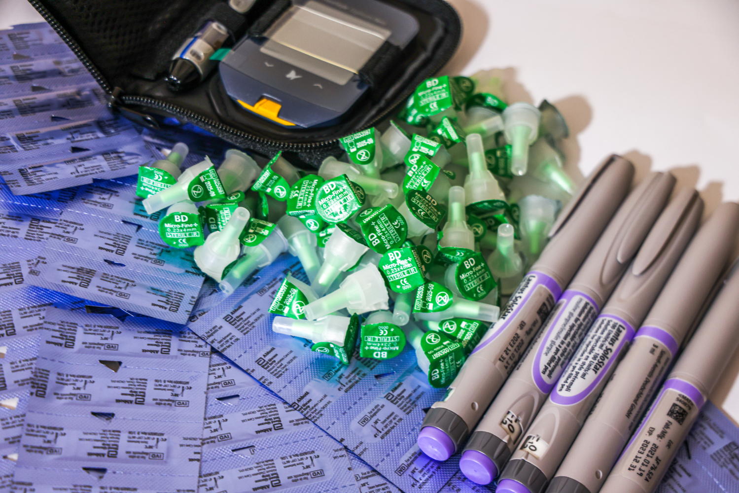 A collection of insulin pens and needle caps beside a glucometer at the MSF clinic in Arsal, north Lebanon, where MSF re-introduced insulin pens as part of its free medical care for people living with type 1 diabetes |Photographer: Carmen Yahchouchi | Date taken: 30/05/2023