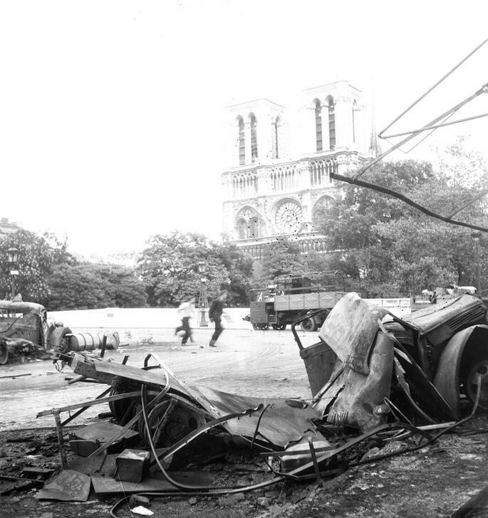 View of Notre-Dame Cathedral from the Quai Saint-Michel, at the corner of the Petit-Pont (now Petit-Pont-Cardinal-Lustiger). In the foreground, wrecked vehicles.  AKG10793408  © René Zuber / akg-images