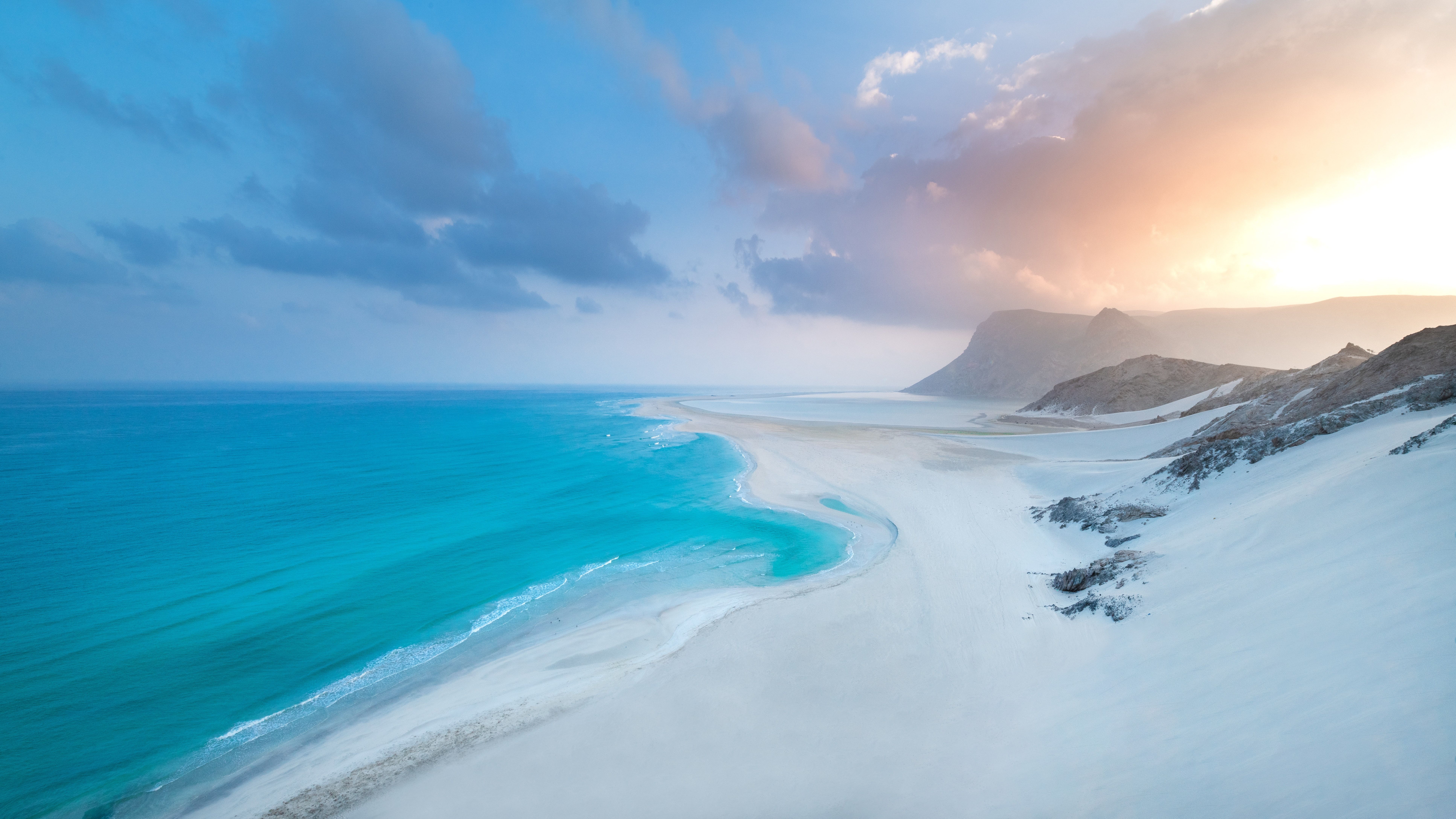 Beautiful beach with mountains and a perfect looking sky. So pristine and with cliffs seen on the far end as well, gorgeous! Beautiful beach with mountains and a perfect looking sky. So pristine and with cliffs seen on the far end as well, gorgeous!