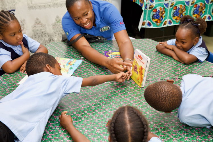 OECS Commission Staff reading to students as part of the USAID/OECS ELP Reading Road Show held in Saint Lucia