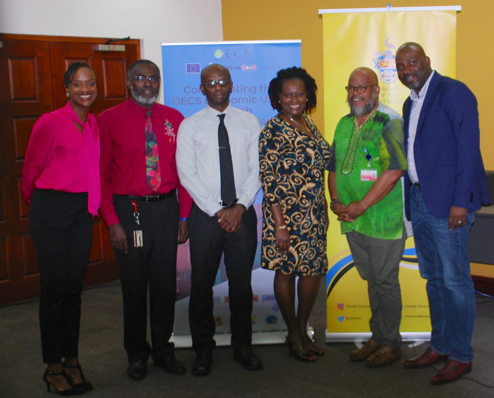 L-R (Dr. Jan Yves Remy, SRC Deputy Director; Mr. Owen Ellis, Senior Assistant Registrar – Graduate Studies and Research; Prof. Winston Moore, Deputy Principal; Dr. Wendy Grenade, Head of the Department of Government, Sociology, Social Work and Psychology; Mr. Neil Paul, SRC Director and Mr. Winsbert Louison, ACP TradeCom II Programme Project Manager at the OECS Commission). 